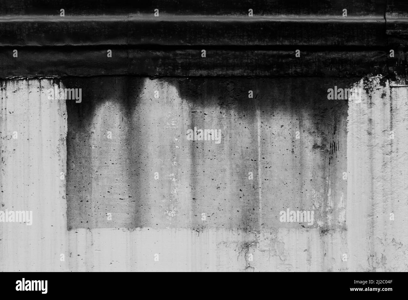 Black dirty spots of fuel oil flow liquid down spill the white old wall surface chemical industry streak background. Stock Photo