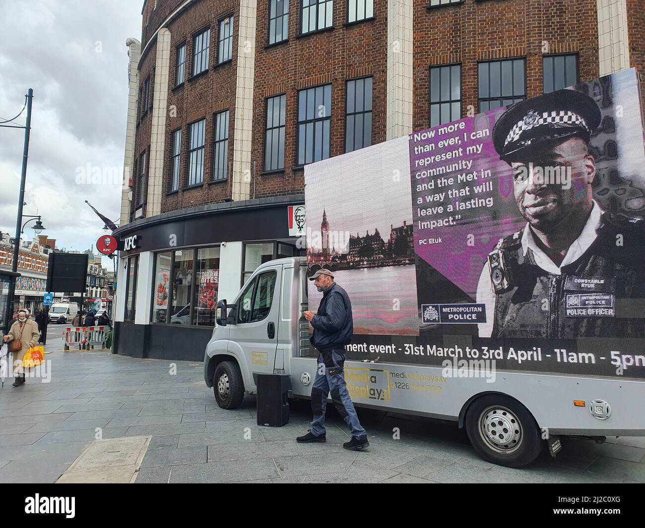 Brixton, UK, 31 March 2022: London's Metropolitan Police are trying to recruit new officers representing a more diverse range of ethnicities, genders and sexualities. Several recent scandals have highlighted the problems of racism, homophobia and misogyny within the police force and the Met's recruitment drive includes this advertising van in central Brixton with an LED screen and speakers broadcasting that 'now more than ever' new recruits are needed to improve diversity, inclusion and representation within London's police. Anna Watson/Alamy Live News Stock Photo