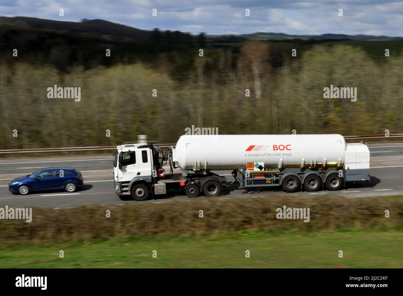 Newport, Wales - March 2022: Articulated BOC tanker lorry driving on a dual carriageway, with slow shutter used to blur motion. Stock Photo