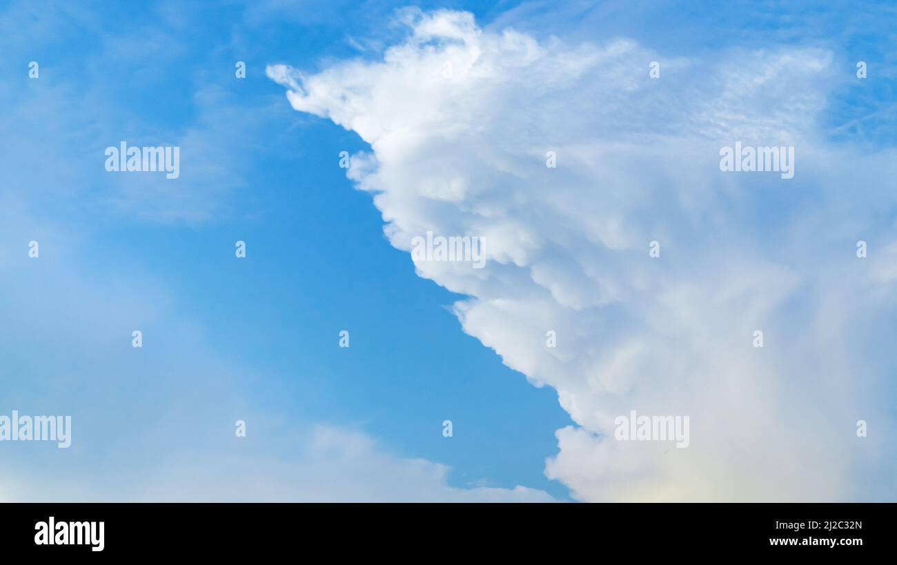 Blue sky with white clouds. Natural background photo of cumulus type of clouds Stock Photo
