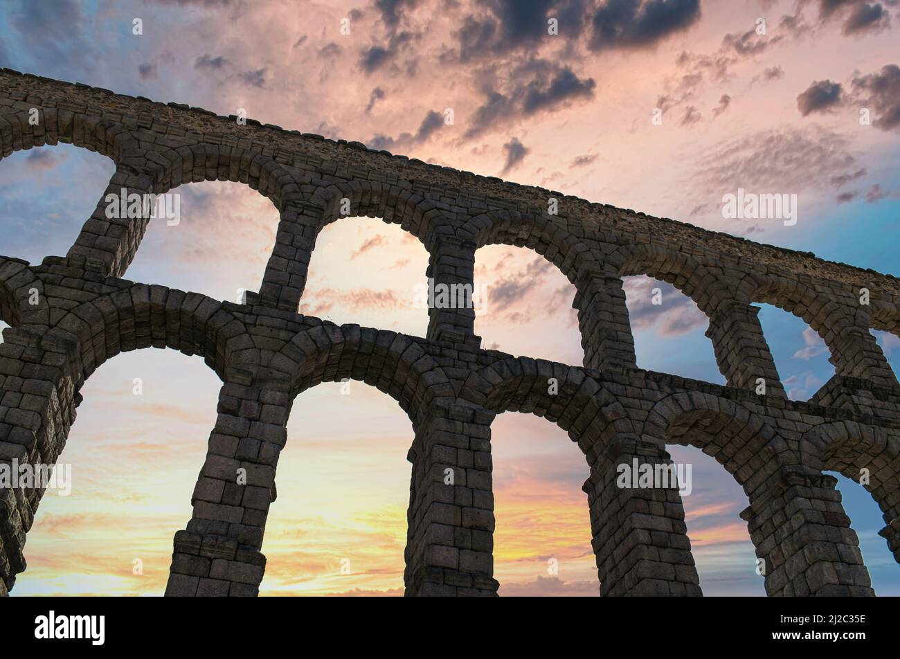 A low angle shot of the Roman aqueduct of Segovia in Spain against ...