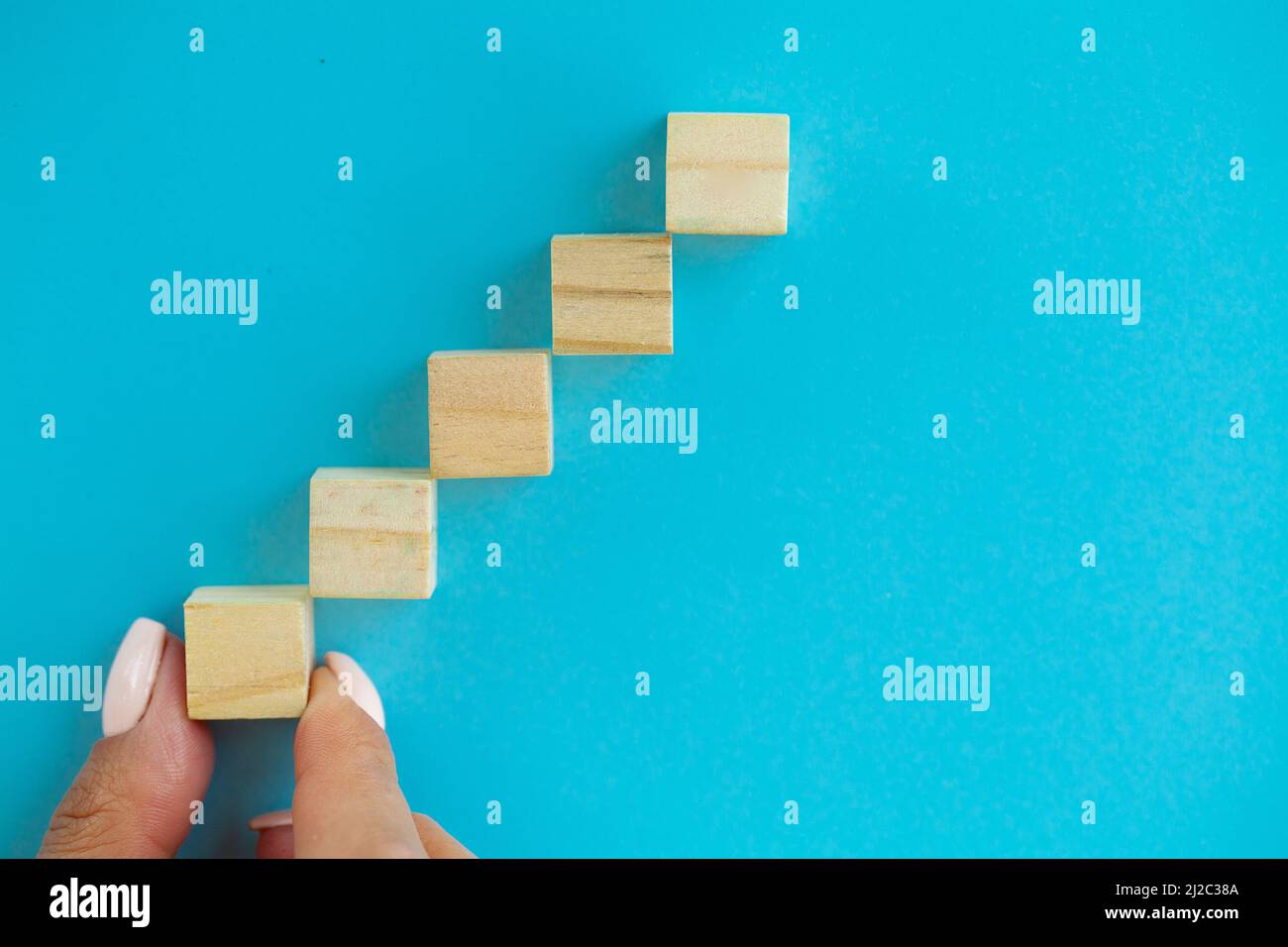 Hand arranging wood block with empty space Stock Photo - Alamy