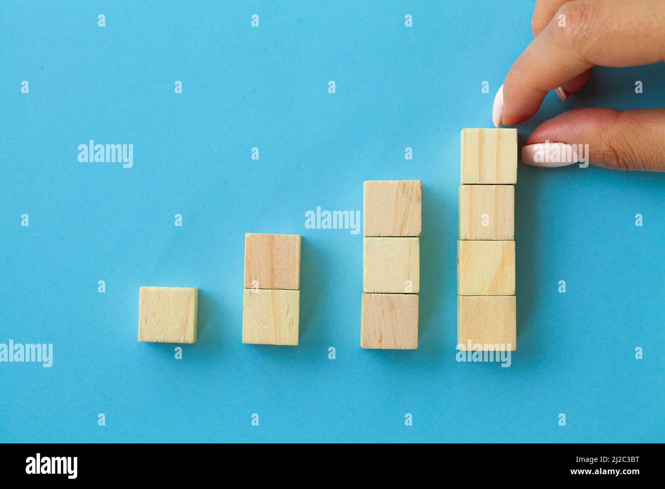 Hand arranging wood block with empty space Stock Photo - Alamy