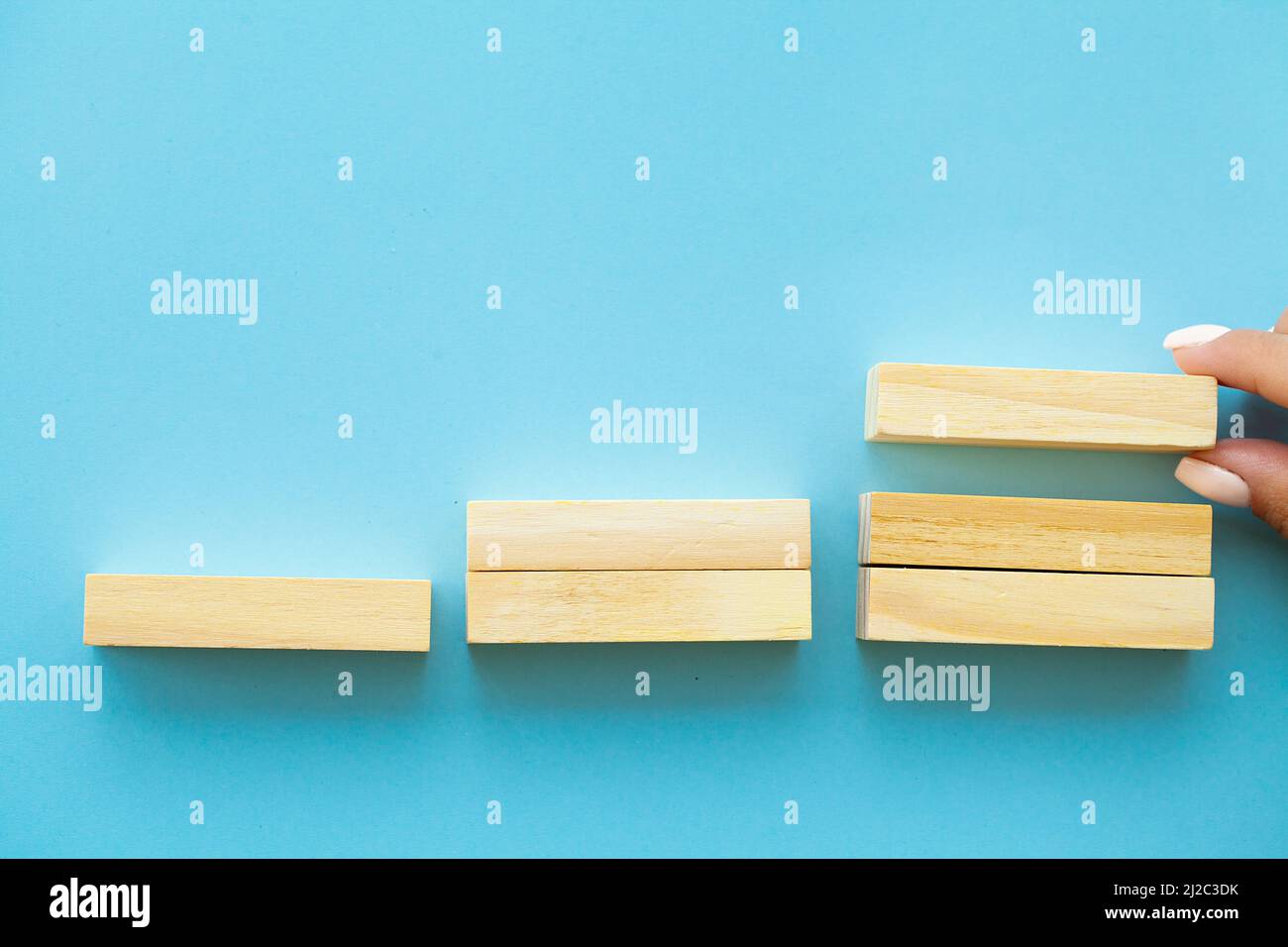 Hand arranging wood block with empty space Stock Photo - Alamy