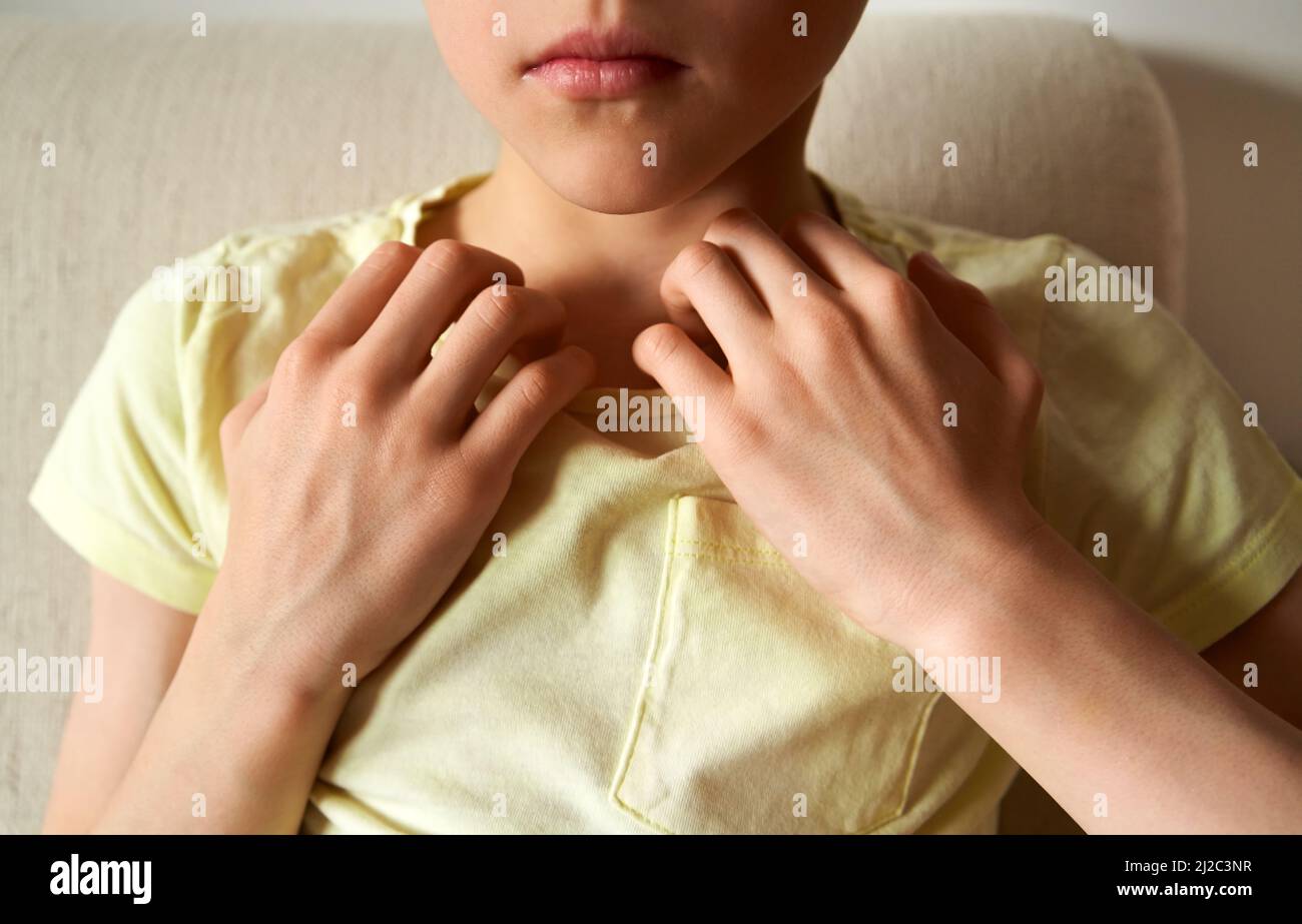Child doing emotional freedom technique or EFT - tapping on the collarbone acupressure point Stock Photo