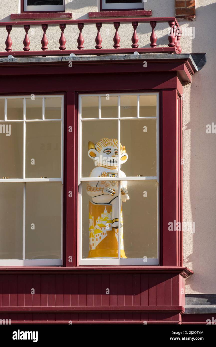 Yellow Belly imp Lincoln imp in window looking out over Sincil street Lincoln city 2022 Stock Photo