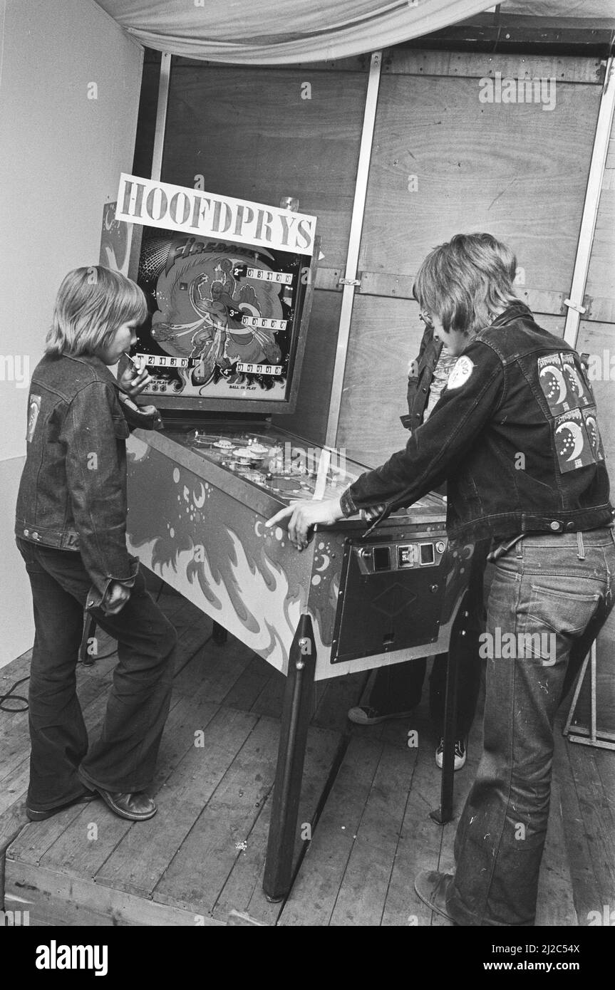 Pinball championships on Museumplein Amsterdam, boys watch pinball machine around June 15, 1976