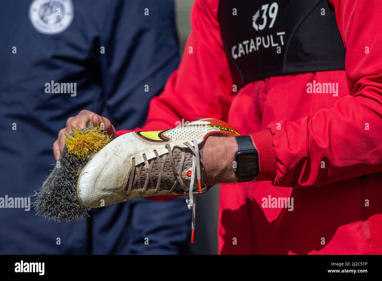 Football / soccer boots being cleaned by players Stock Photo