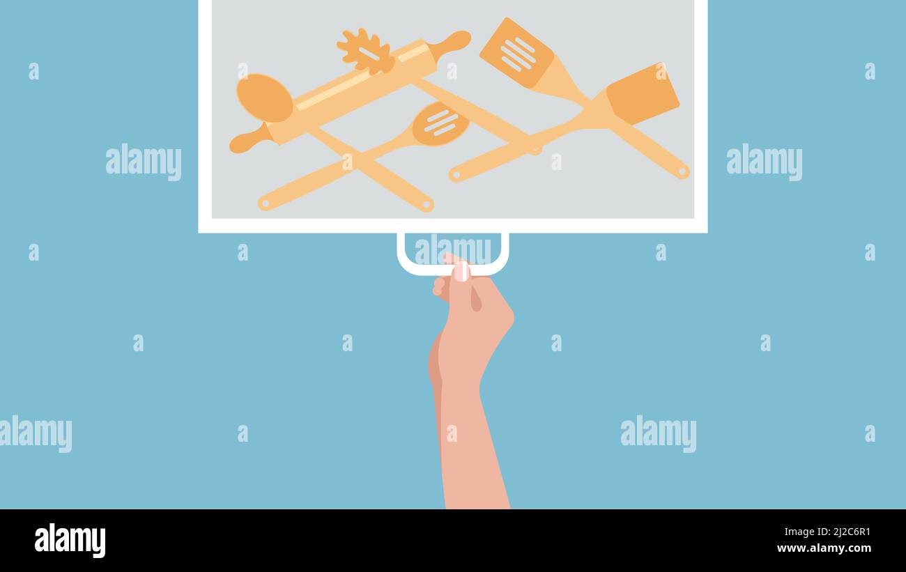 Kitchen drawer with wooden spoons and spatulas. A female hand opens a