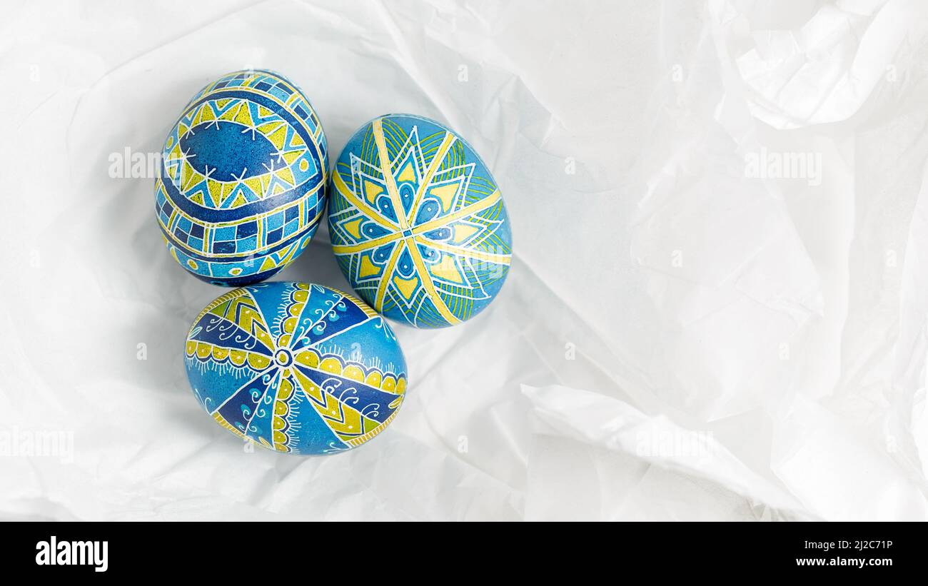 Ukrainian Easter eggs Pysanky on the white crumpled paper background