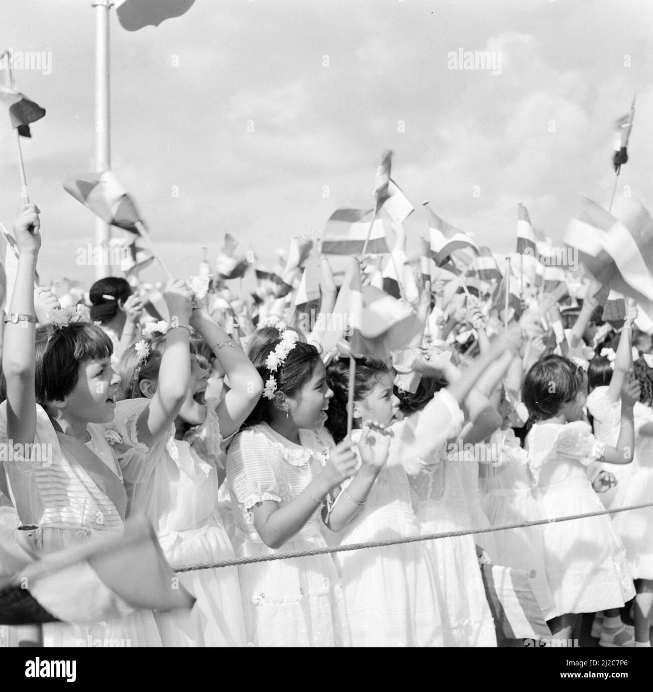 Children with flags at the arrival of the royal couple in Aruba ca: October 24, 1955 Stock Photo