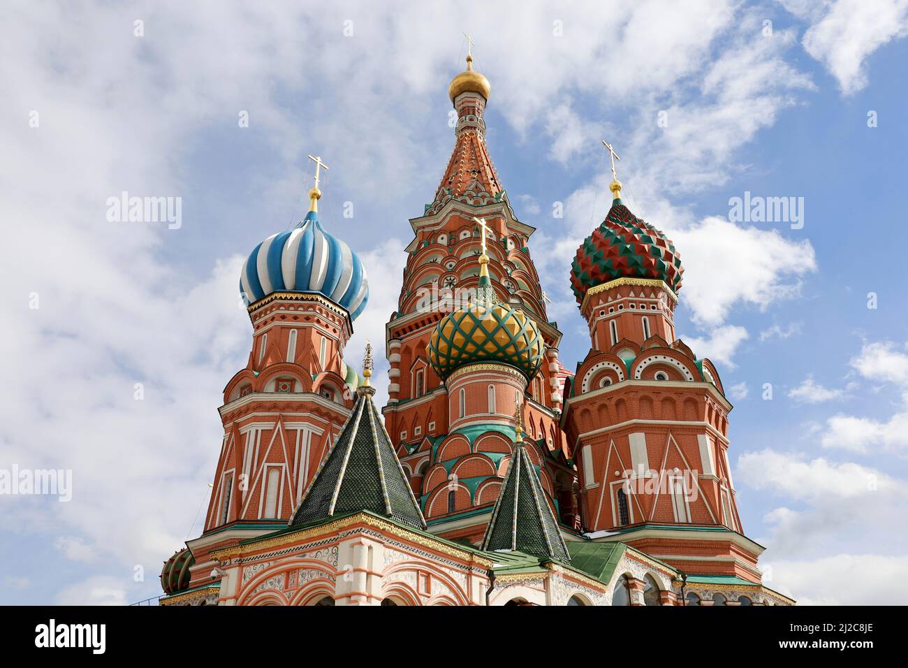 St. Basil's Cathedral against the blue sky and white clouds. Russian tourist landmark on Red Square in Moscow Stock Photo