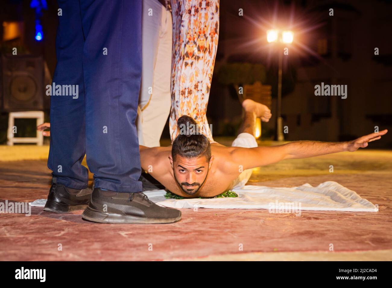 Actor fakir stuntman lies on broken glass Stock Photo