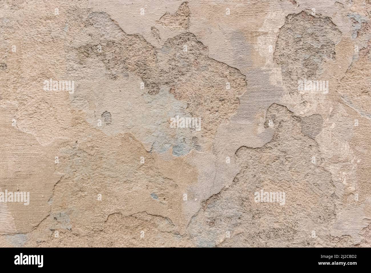 Peeling old plaster with damaged concrete wall cement weathered texture broken background. Stock Photo