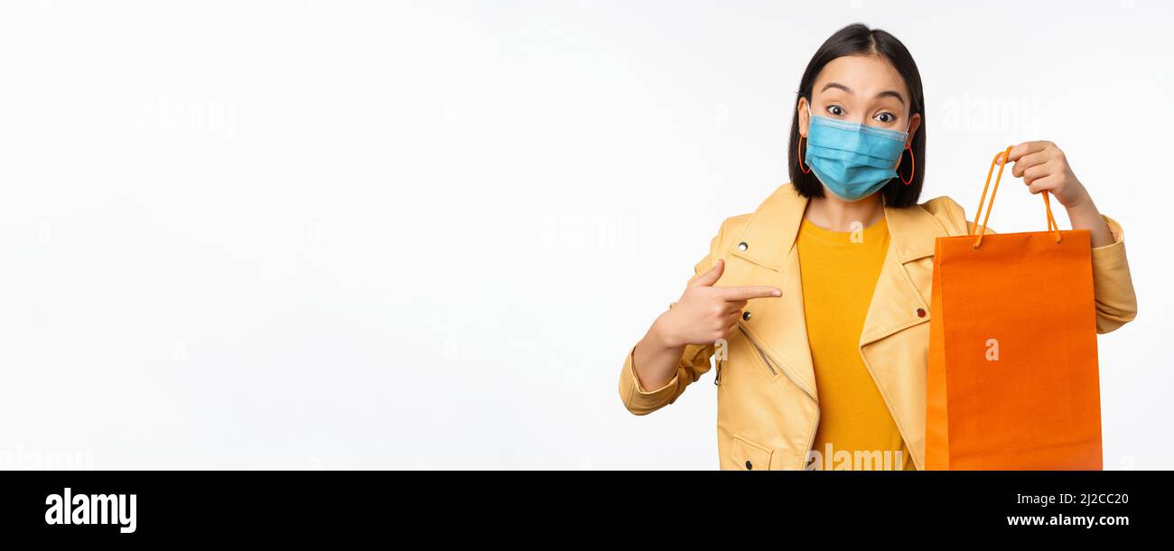Covid19 and shop concept. Young asian stylish woman, wearing medical