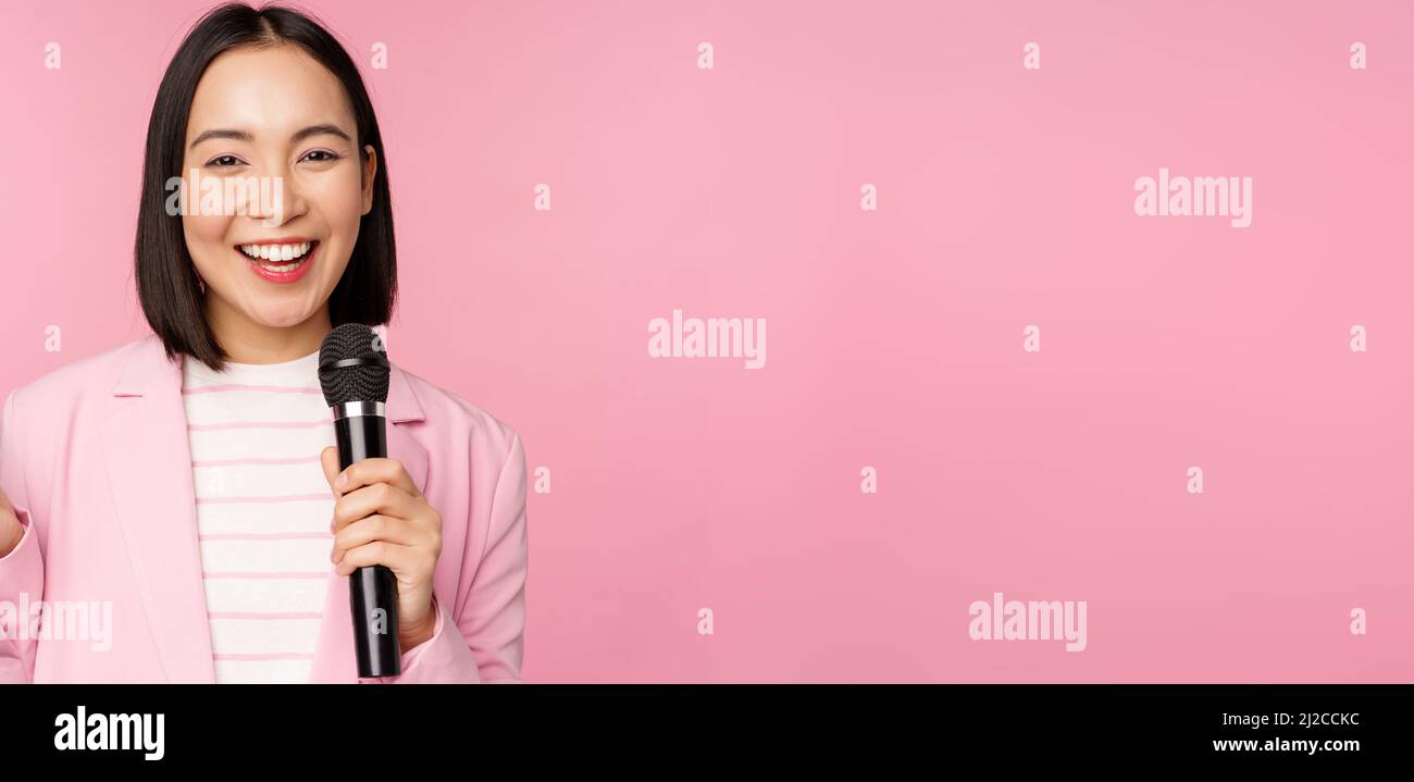 Image of enthusiastic asian businesswoman giving speech, talking with
