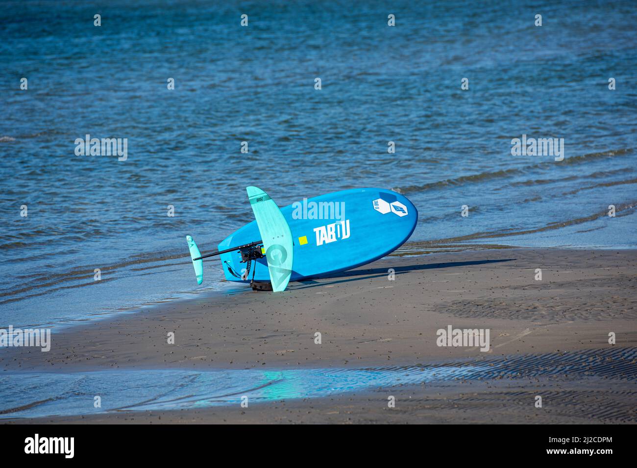 Blue Tabou foiling board on a beach Stock Photo