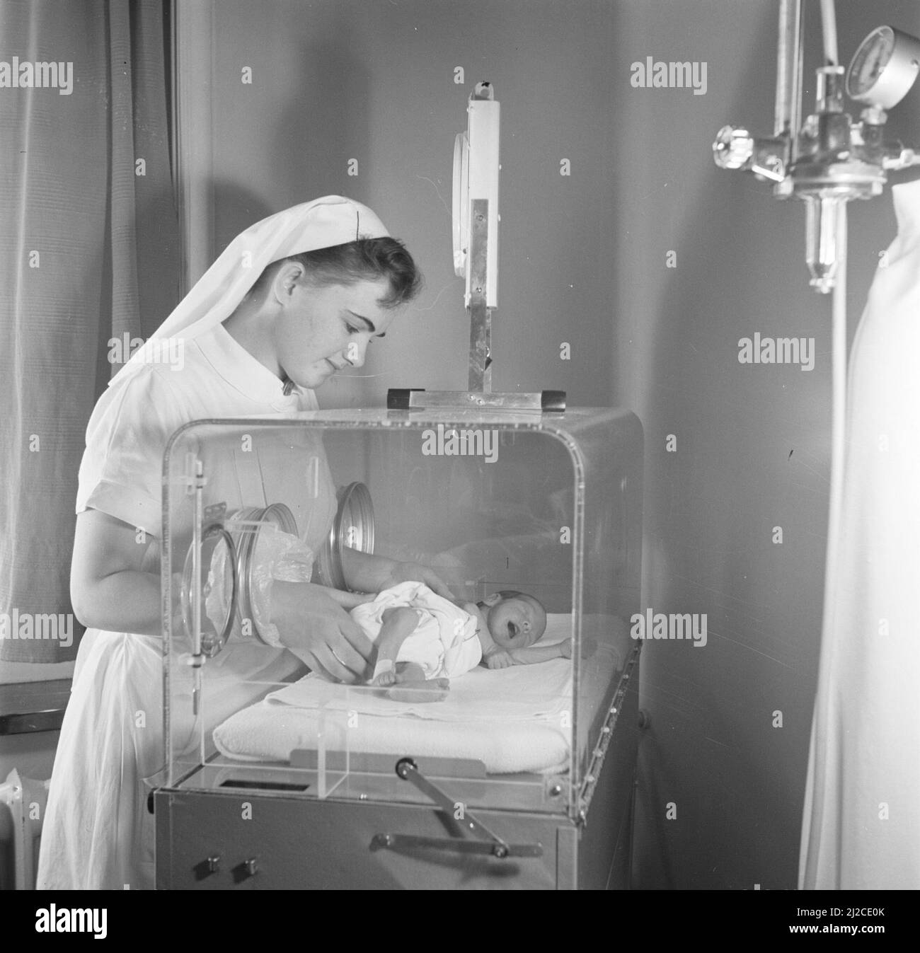 Nurse with premature baby Martin in an incubator, presumably in the
