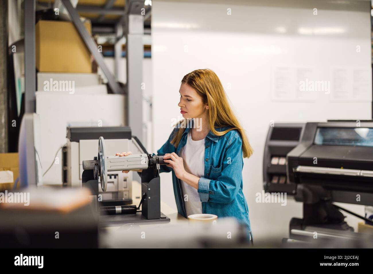 Young woman working in an industrial place of work Stock Photo