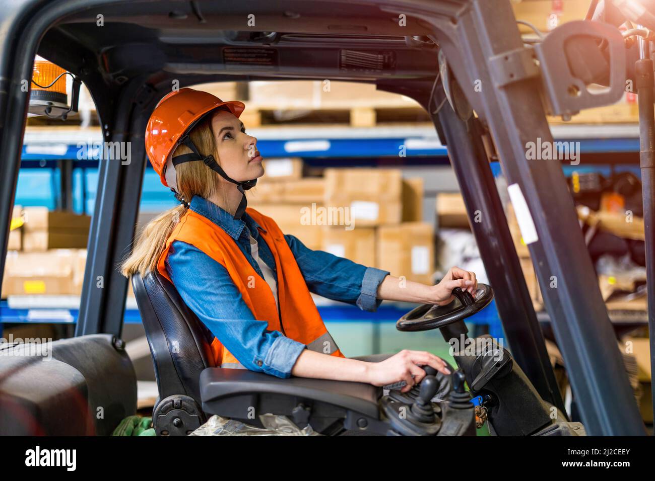 Young female forklift driver working in a warehouse Stock Photo Alamy