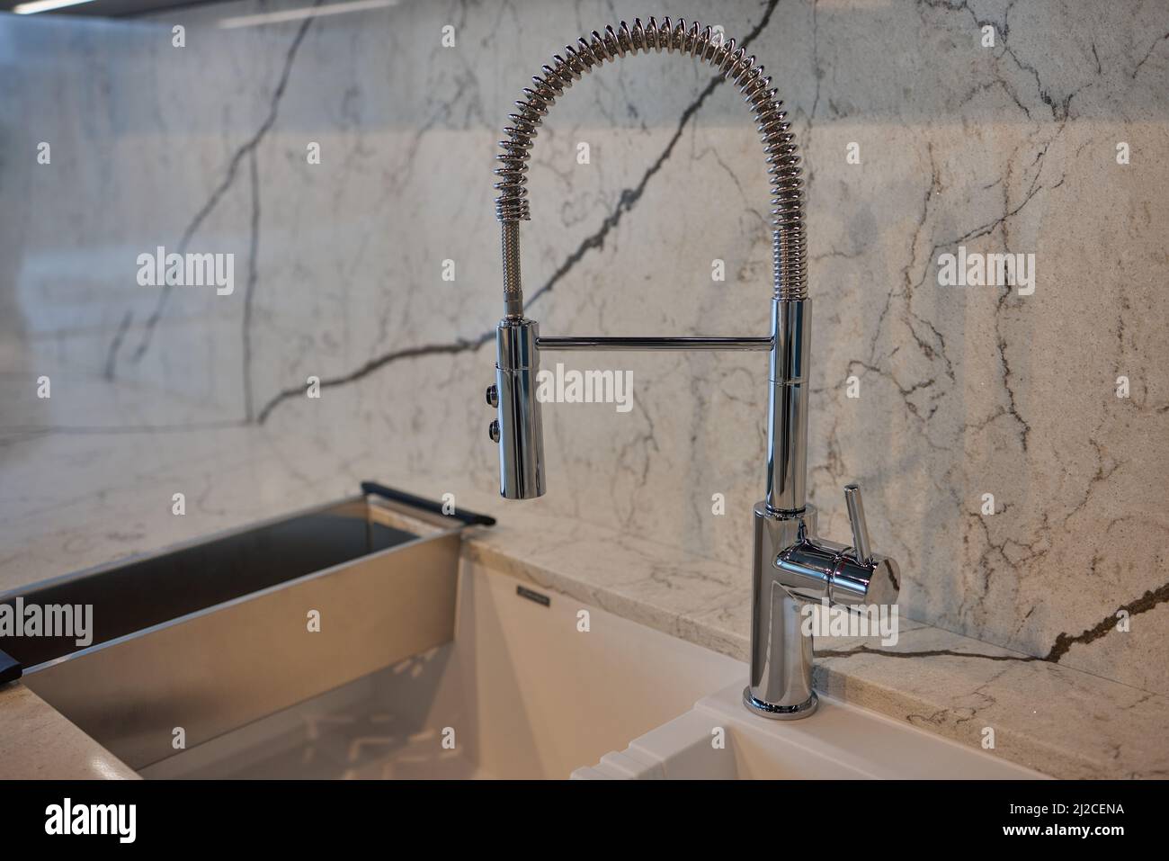 Kitchen water mixer. Water tap made of chrome material Stock Photo