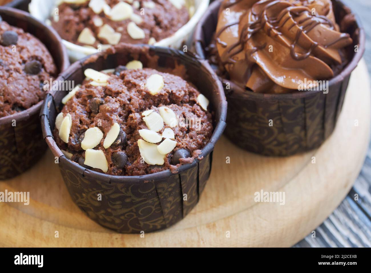 Chocolate muffins with different fillings. On pine boards. Shot close