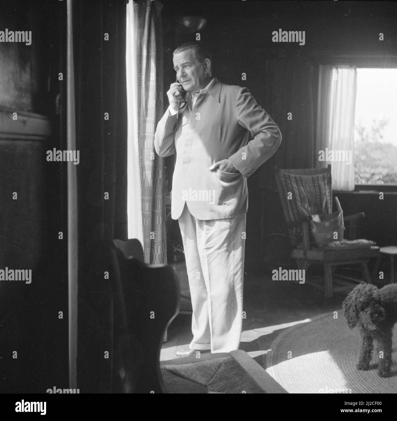 The conductor Eduard van Beinum is on the phone in the room of his Bergsham country house in Garderen ca: June 5, 1954 Stock Photo