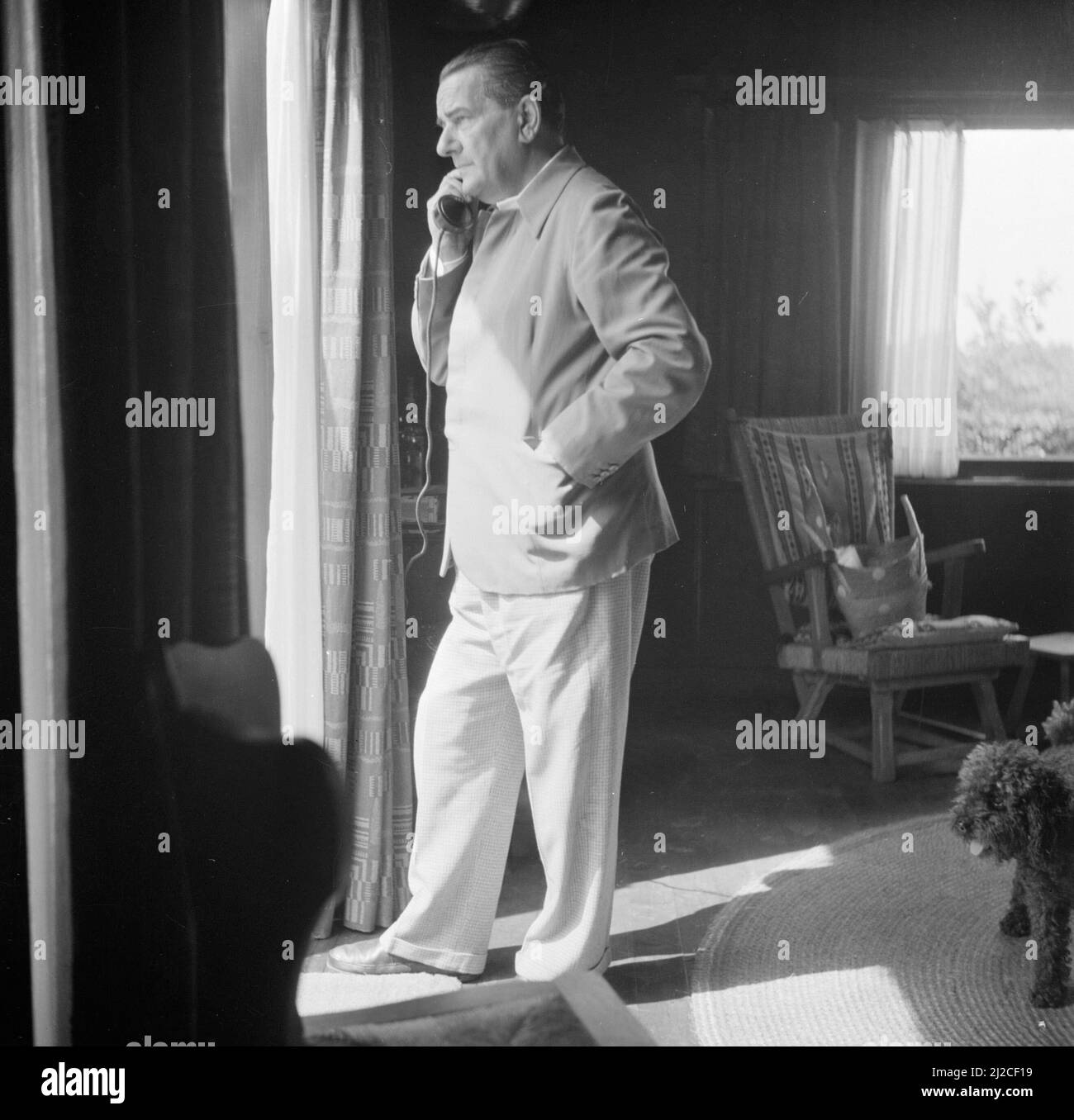 The conductor Eduard van Beinum is on the phone in the room of his Bergsham country house in Garderen ca: June 5, 1954 Stock Photo