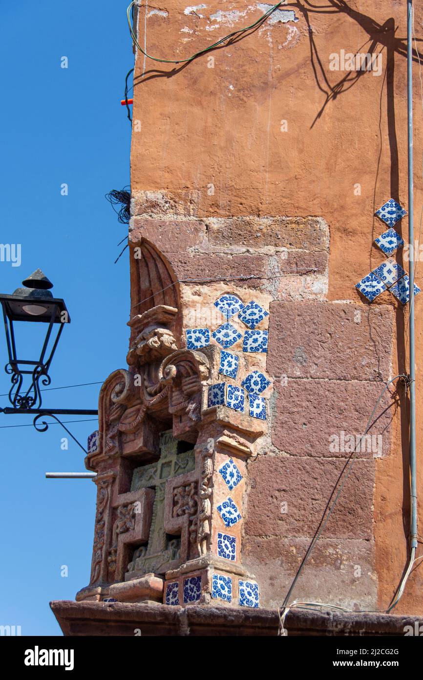 A broken wall filled in with pieces of tile. San Miguel de Allende