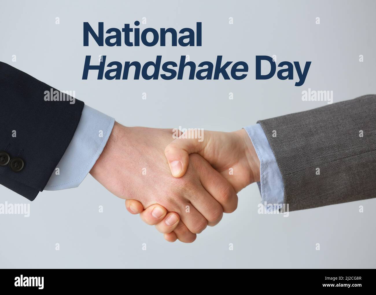 Businessmen shaking hands on light background. National Handshake Day Stock Photo Alamy