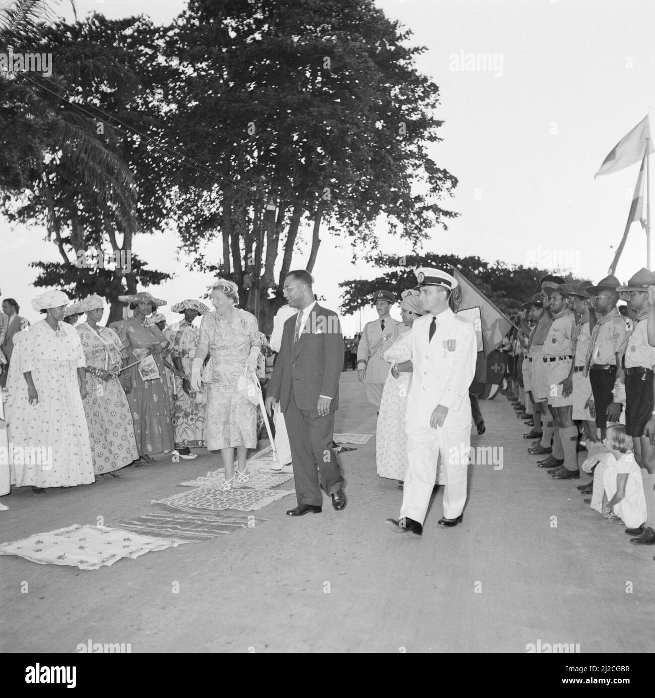 Queen and Prince walk through Dumburg. Right Governor Klaasesz and Johan Ferrier, President of the Council of Ministers ca: October 27, 1955 Stock Photo