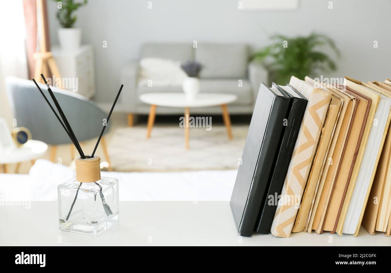 Open Book Diffusers Books and reed diffuser on shelf in light room, closeup Stock Photo - Alamy