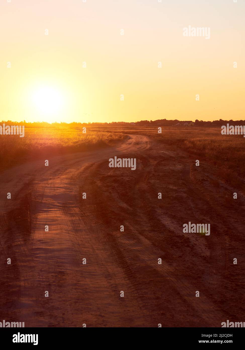 Sunrise in field with path on early autumn morning. Stock Photo