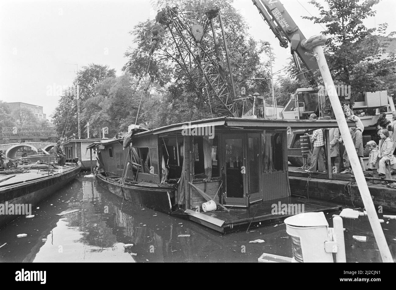Sunken houseboat being lifted (Amsterdam) ca. 30 July 1976 Stock Photo