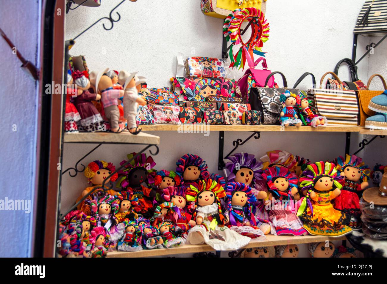 Two shelves of Mexican style dolls in a toy store in the city of San Miguel de Allende, Guanajuato, Mexico Stock Photo
