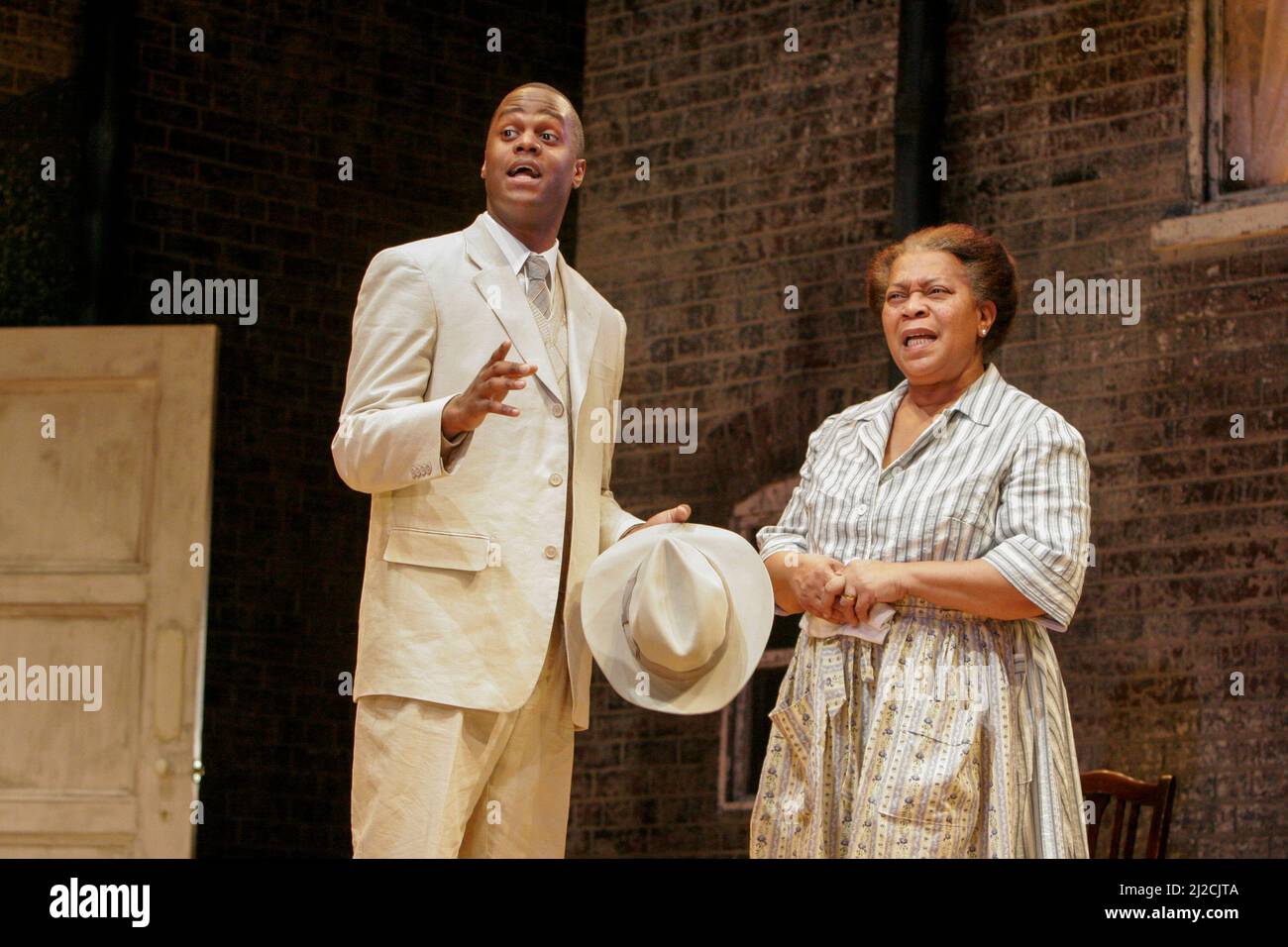 Javone Prince (Joseph Asagai), Novella Nelson (Lena Younger / Mama) in A RAISIN IN THE SUN by Lorraine Hansberry at the Lyric Hammersmith, London W6  24/02/2005  a Young Vic Theatre Company / Salisbury Playhouse co-production  design: Francis O’Connor  lighting: Tim Mitchell  director: David Lan Stock Photo