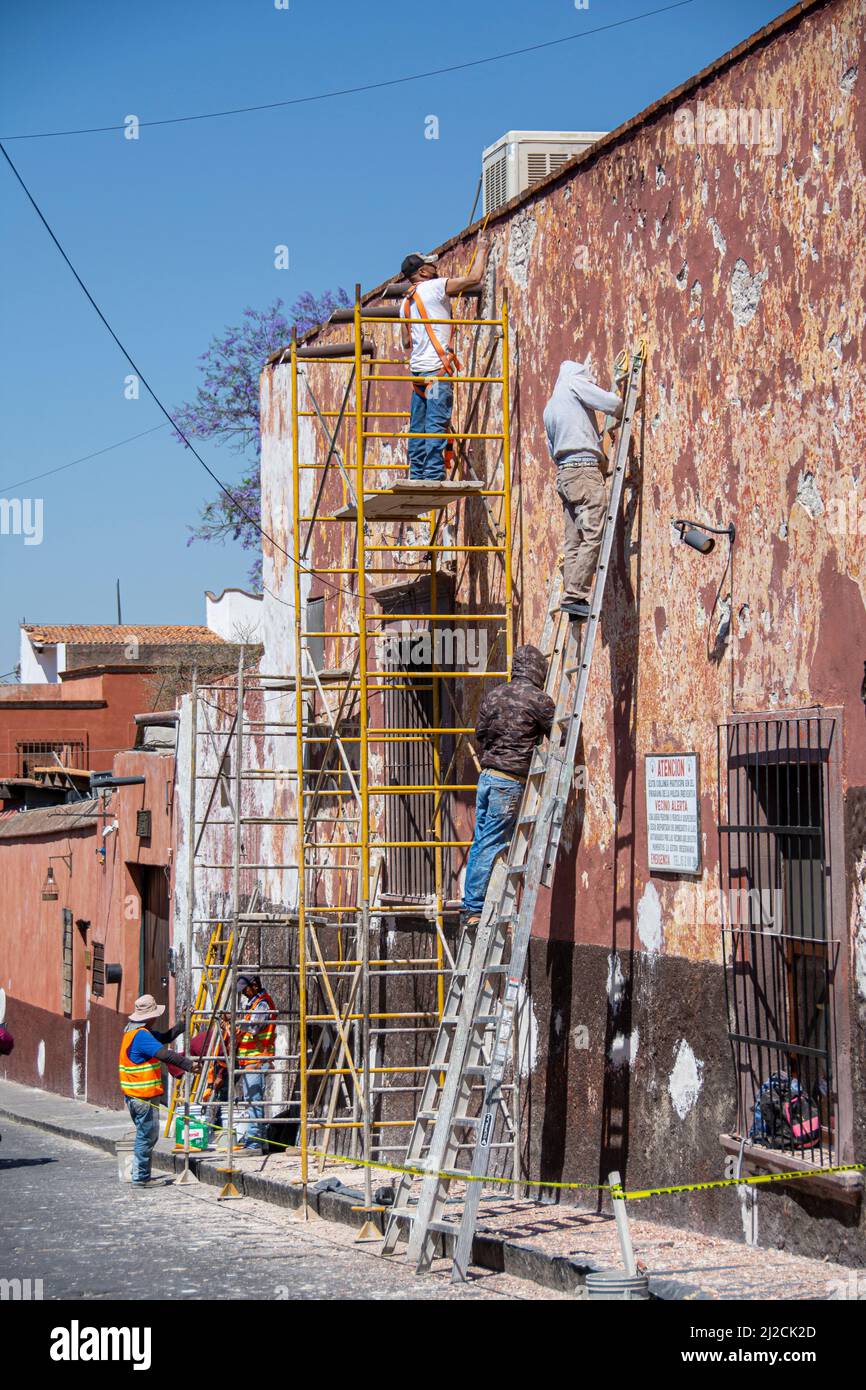 Mexican laborers at work. Refinishing a building. San Miguel de Allende, Guanajuato, Mexico Stock Photo