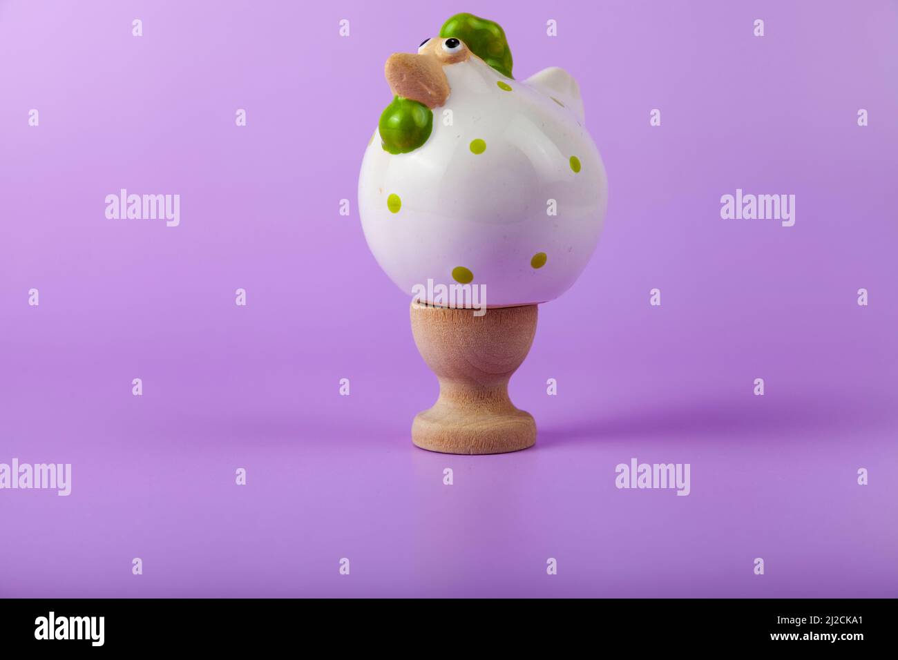 Easter card design. Easter chick on a stand  on lilac background. Stock Photo