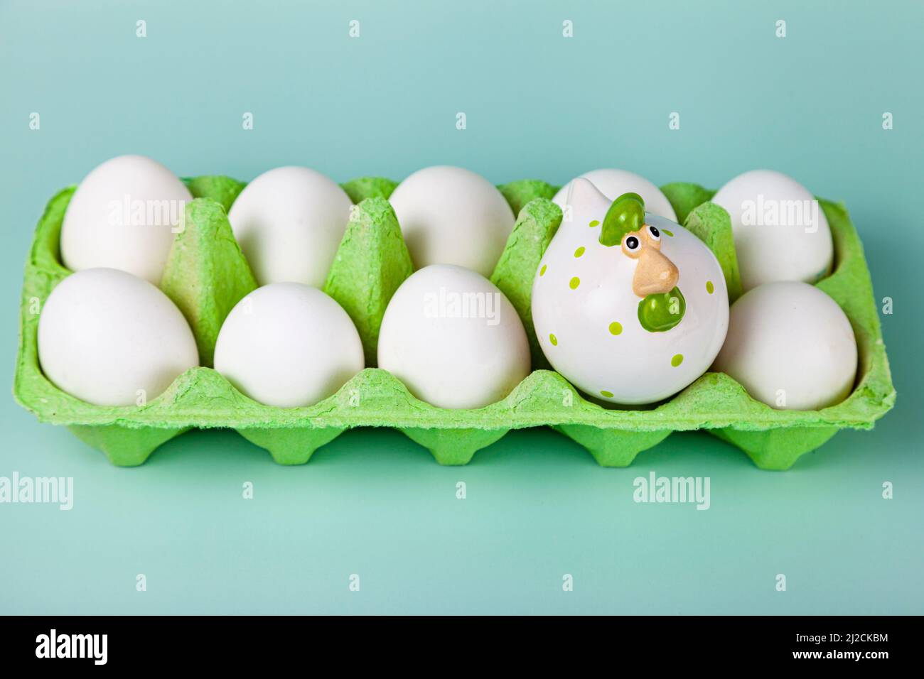 Happy Easter. Easter eggs. Chicken white eggs on green background. Easter chicken. Closeup. Stock Photo