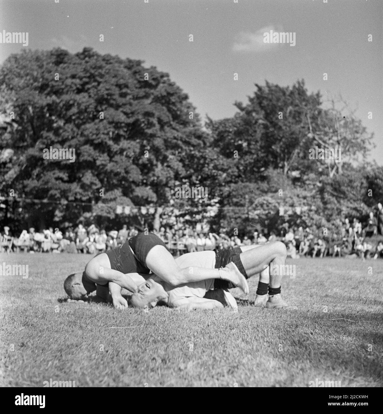 Wrestling at the Highland Games, a 19th century continuation of traditional clan games from the Highlands of Scotland ca: 1934 Stock Photo