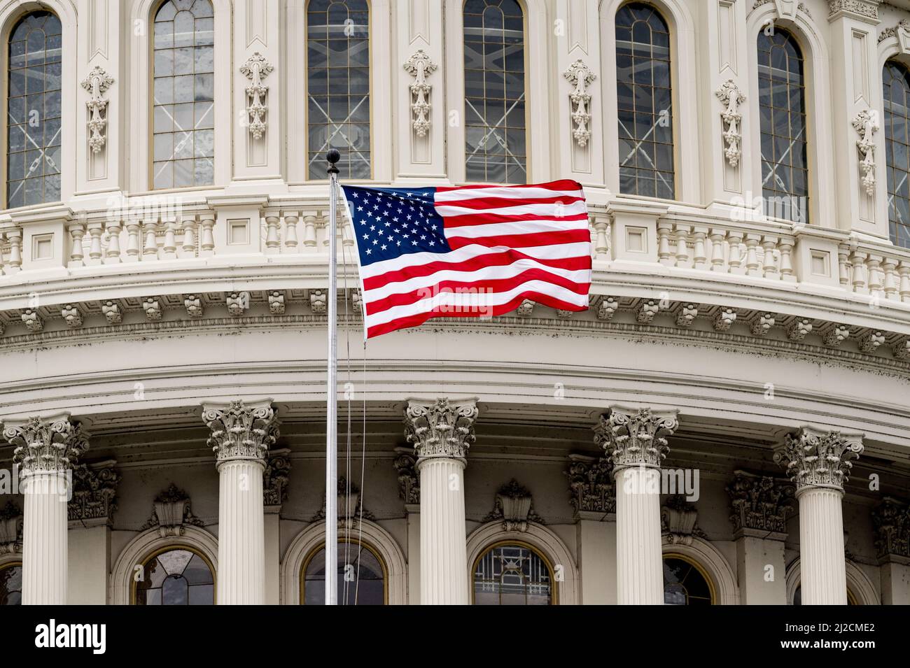 American flag flying above the U.S. Capitol Stock Photo - Alamy
