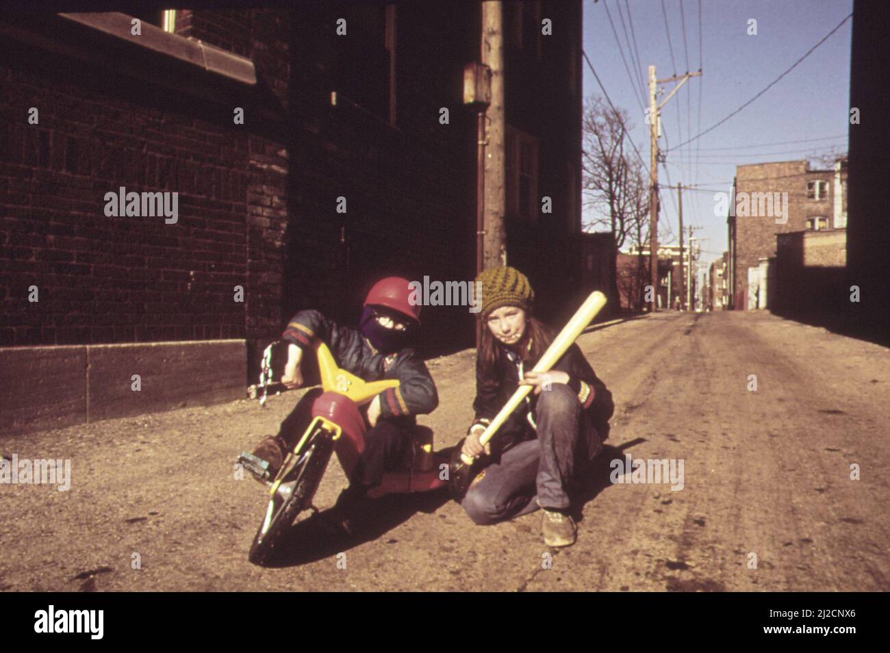 Boy riding on a Big Wheel in an alley in Rogers Park, north side of Chicago  ca.  1973 Stock Photo