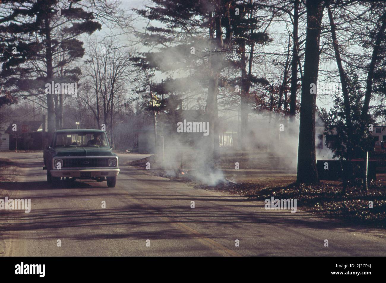 Burning leaves near Bass Lake  ca.  1973 Stock Photo