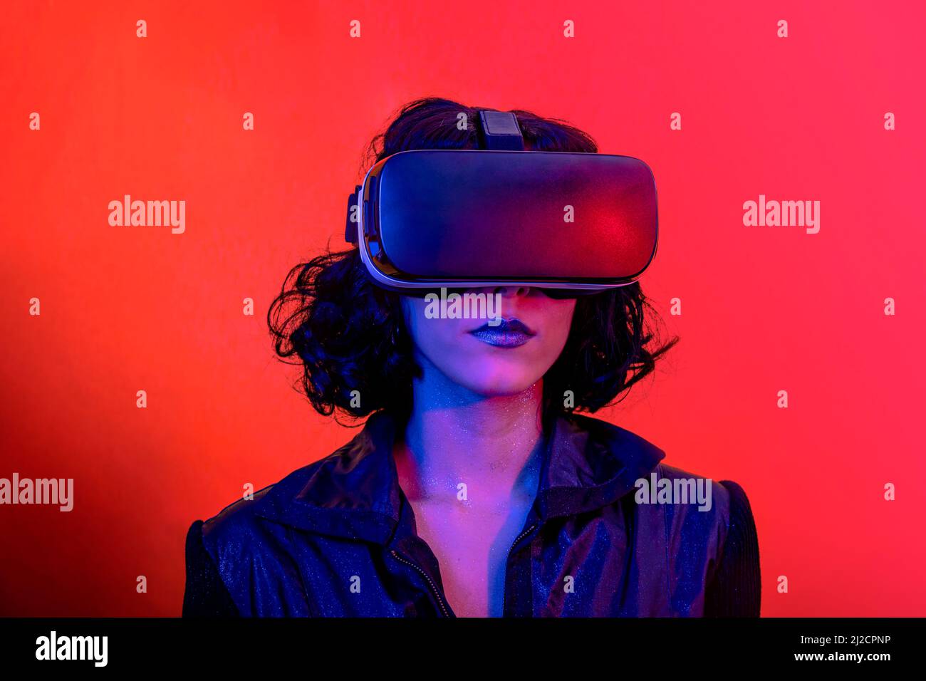 The young woman is using the virtual reality headset. Modern woman ...
