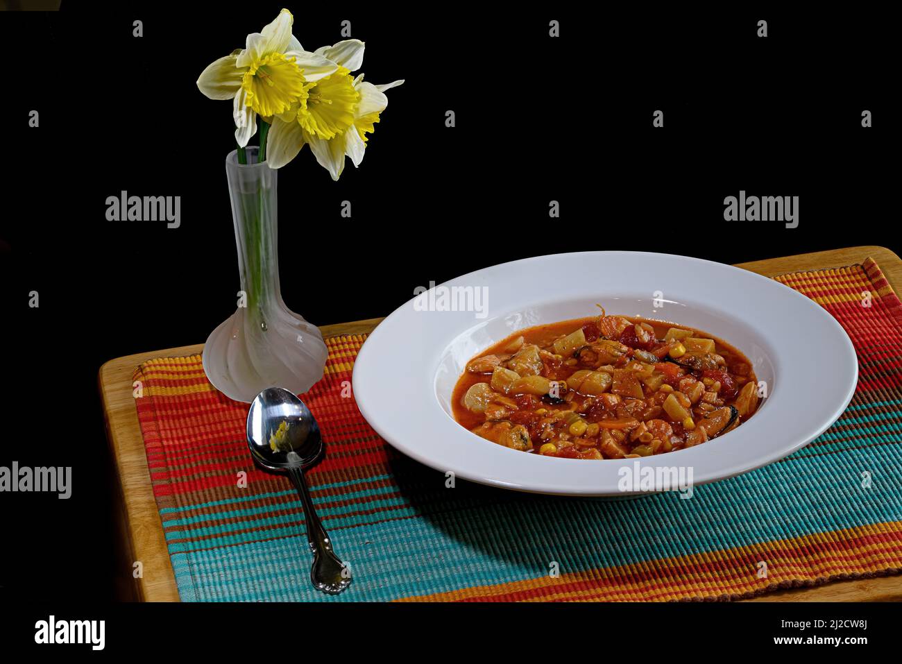 A bowl of homemade fish stew comprised of sustainably harvested scallops, shrimp, squid, muscles and white fish. Stock Photo