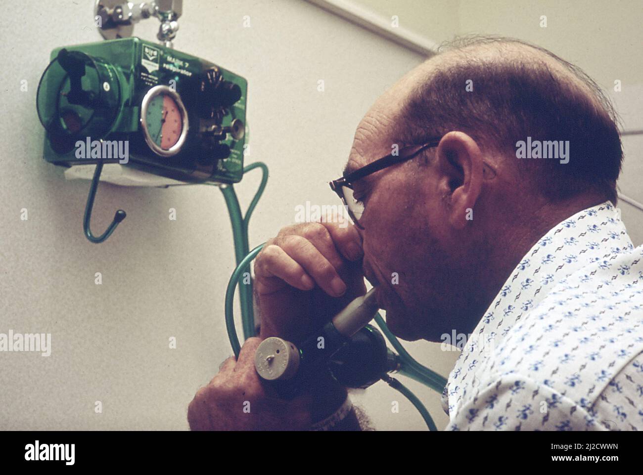 An emphysema patient uses a lung function testing machine to measure