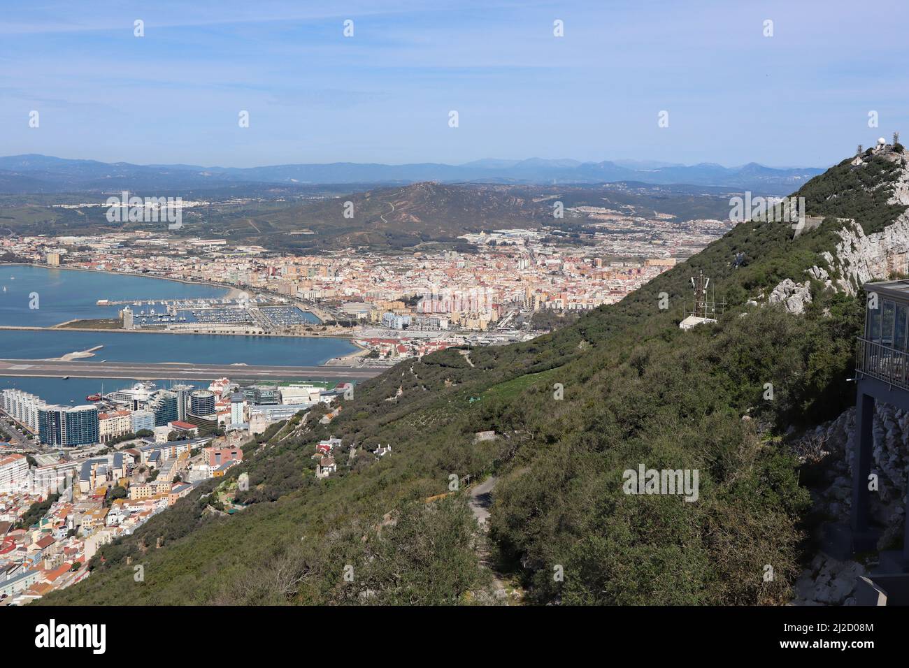 Panoramic view over Gibraltar harbour from the top of the Rock of Gibraltar. The airport runway juts out into the water. Stock Photo