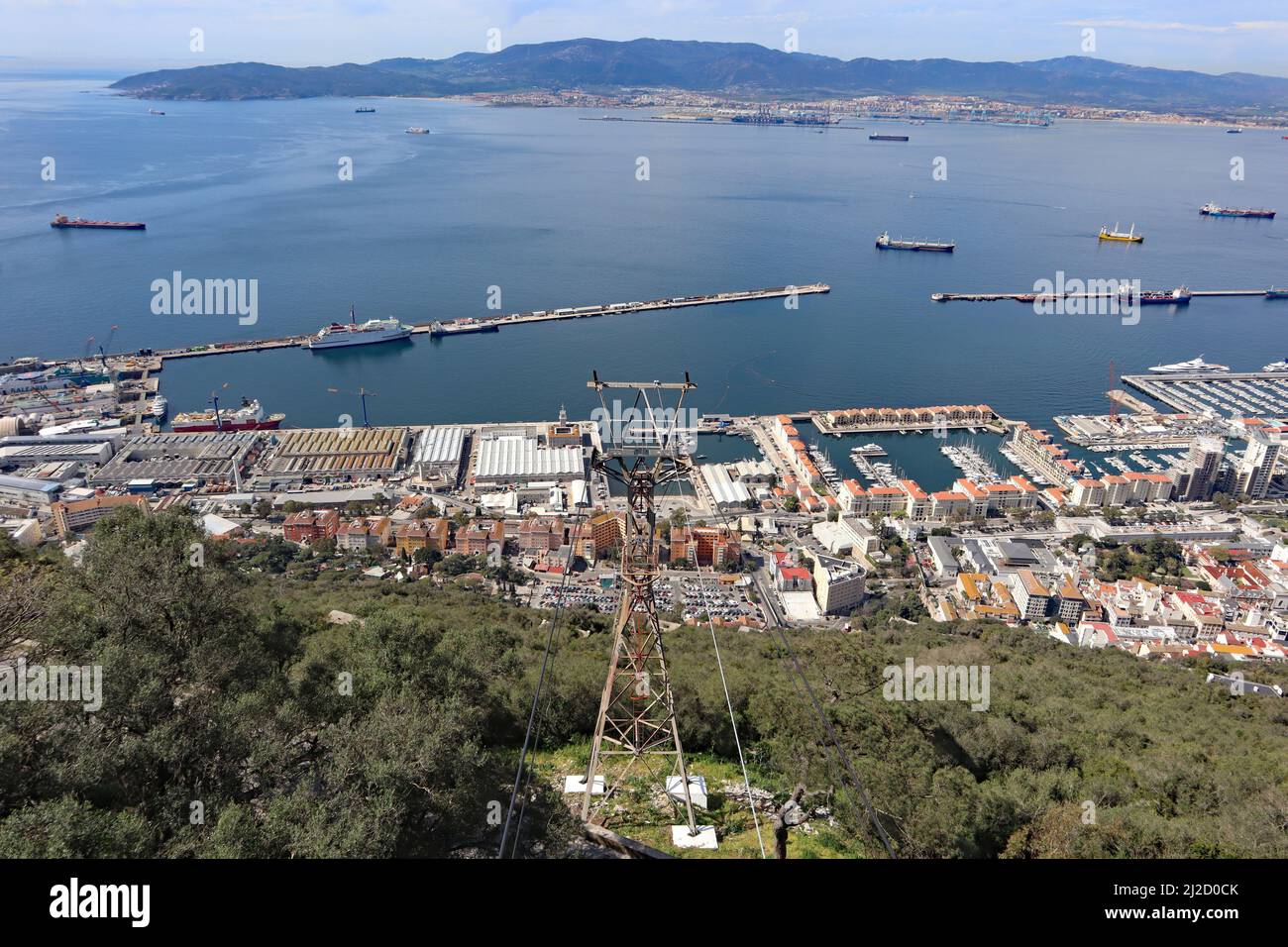 Panoramic view over Gibraltar harbour from the top of the Rock of Gibraltar. The airport runway juts out into the water. Stock Photo