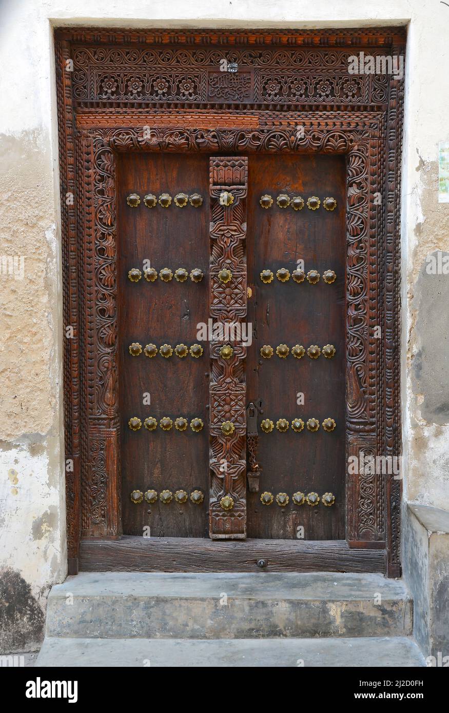 Old wooden doors with traditional carvings of Indian origin on the ...