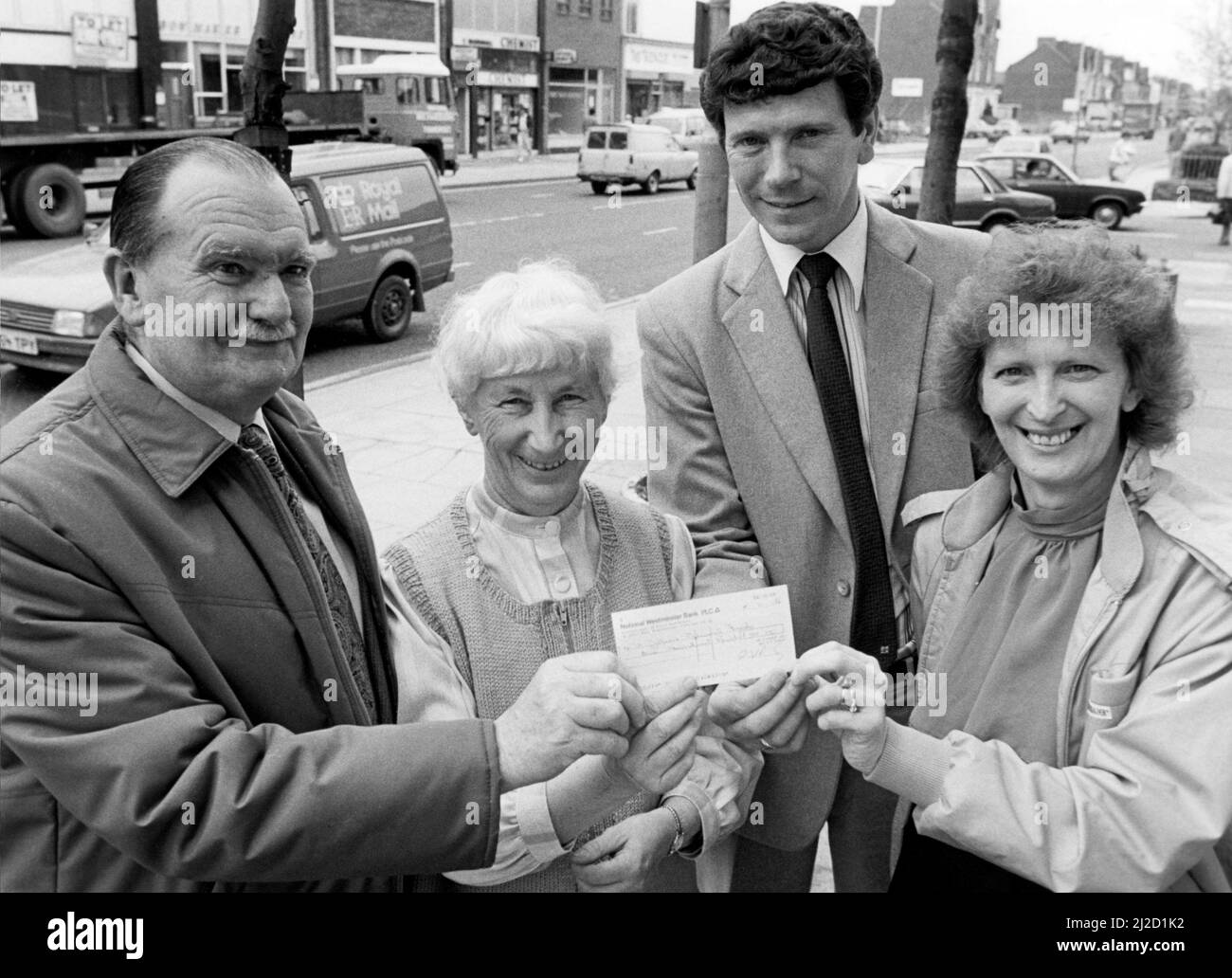 Churchwarden Allan Fletcher and church treasurer Mary Wairing (left) receiving a cheque from David Connor and Jacqueline Knight (right) organisers of a reunion which raised ¿100 for the restoration of St John's Church, Marton Road, Middlesbrough, 2nd June 1986. Stock Photo